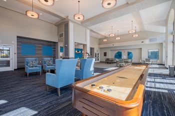 A recreation room with a foosball table and chairs